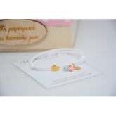 Μαρτυρικό λευκό με χάντρες γαλάζιες και ροζ (δημιουργήθηκε για δίδυμα) με αστεράκι και σταυρό