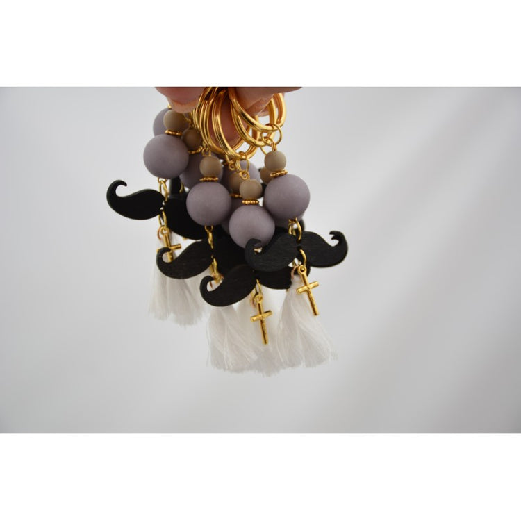 Μαρτυρικό μπρελόκ μουστάκι σε γκρι μαύρες αποχρώσεις , με φουντίτσα λευκή