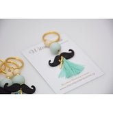 Μαρτυρικό μπρελόκ μουστάκι σε βεραμάν εκρού αποχρώσεις , με φουντίτσα βεραμάν