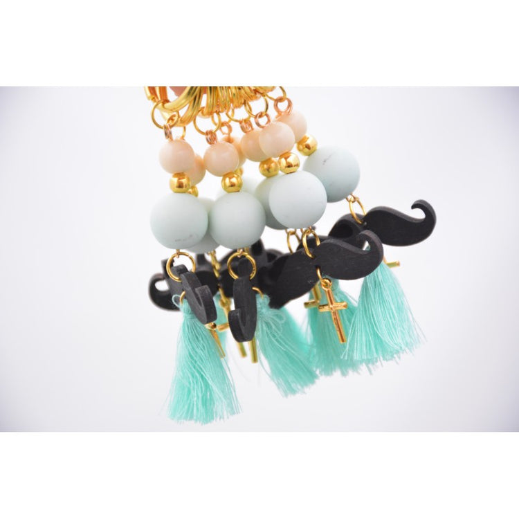 Μαρτυρικό μπρελόκ μουστάκι σε βεραμάν εκρού αποχρώσεις , με φουντίτσα βεραμάν