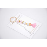 Μαρτυρικό μπρελόκ με ιδιαίτερες χάντρες σε ροζ - λευκό και φιογκάκι στο τέλος