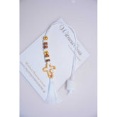 Μαρτυρικό μπεγλέρι σε αποχρώσεις λευκό-μπεζ με ιδιαίτερο σταυρό και φουντίτσα