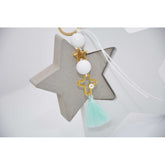 Μαρτυρικό μπρελόκ με αστέρι & ιδιαίτερο σταυρό μάτι με λευκές χάντρες & βεραμάν φούντα