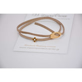 Μαρτυρικό βραχιόλι με ιδιαίτερο σουέντ κορδόνι μπεζ, περαστό σταυρό με σμάλτο λευκό 