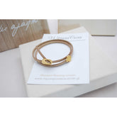 Μαρτυρικό βραχιόλι με ιδιαίτερο σουέτ κορδόνι , περαστό σταυρό και κούμπωμα