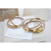 Μαρτυρικό βραχιόλι με ιδιαίτερο σουέτ κορδόνι , περαστό σταυρό και κούμπωμα