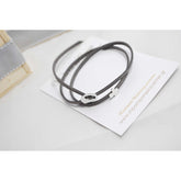 Μαρτυρικό βραχιόλι με ιδιαίτερο σουέτ κορδόνι , περαστό σταυρό και κούμπωμα σε ασημί