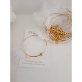 Μαρτυρικό βραχιόλι με ιδιαίτερο δέσιμο , πούπουλο, κρεμαστή μπίλια ροζ,  περαστό σταυρό σε χρυσό