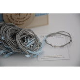 Μαρτυρικό βραχιόλι με ασημί σταυρό, γκρι κορδόνι και σιέλ κορδέλα