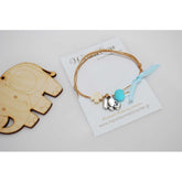 Μαρτυρικό βραχιόλι με διπλό κορδόνι , ξύλινο σταυρό και μεταλλικό ελεφαντάκι