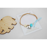 Μαρτυρικό βραχιόλι με διπλό κορδόνι , ξύλινο σταυρό και μεταλλικό ελεφαντάκι