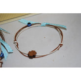 Μαρτυρικό βραχιόλι με σταυρό Μαρτυρικό βραχιόλι καφέ με σταυρό ξύλινο & ματάκι μπλε